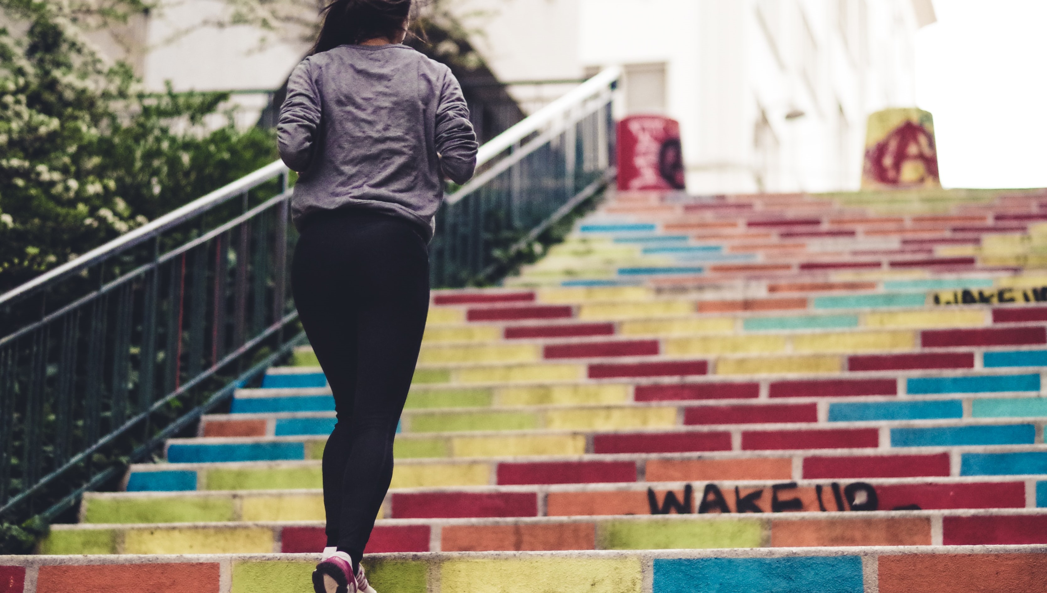 woman running up colourful steps